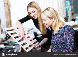 Stylist Helps Female Client To Choose Hair Dye Color With