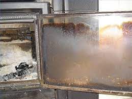 clean the glass door of a wood stove