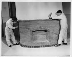 Two Students Building A Brick Fireplace