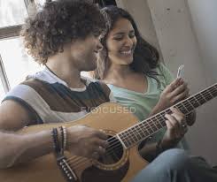 Man playing guitar and a woman with phone — string instrument, guitar  player - Stock Photo | #124366722