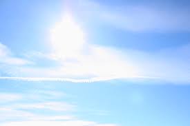 blue sky with sun clouds and airplane