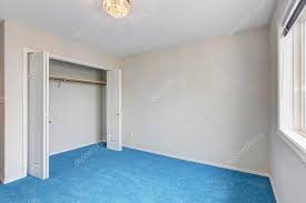 unfurnished bedroom with blue carpet