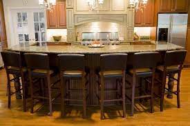 We can help create a kitchen you'll love. Kitchen Island With Seating Sandstone Countertop Wood Cabinets Modern Kitchen Design Modern Kitchen Design Kitchen Lighting Design Kitchen Island With Seating