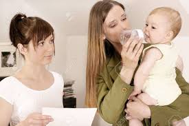 Working Mother Ltalking To A Babysitter About Her Duties Stock Photo