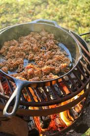 skillet choriqueso over the fire cooking