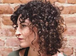Curtain bangs can look great on curly hair. 11 Charismatic Short Curly Hairstyles With Bangs For Women