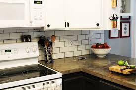 Secure the drop cloth on the counter using the painter's tape, covering the entire work area. How To Install A Subway Tile Kitchen Backsplash