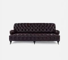 leather sofa with carved wooden legs on