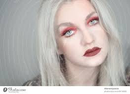 blonde woman with red makeup a