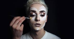 makeup young man applies mascara