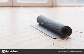 yoga mat on wooden floor stock photo