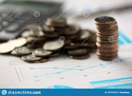 Pile Of Silver Coins Stand At Financial Graph Papers Stock