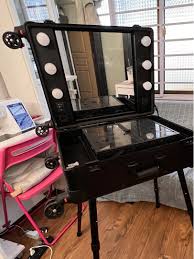 lightly used portable makeup table with