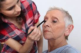 applying makeup to an older lady mother