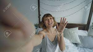 POV Of Cheerful Woman Having Online Video Chat With Friends Using  Smartphone Camera While Sitting On Bed At Home Stock Photo, Picture and  Royalty Free Image. Image 91205134.