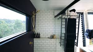 Choosing a mounted sink instead of a full vanity allowed space for a garbage can and small storage stool that can tuck behind the sink, as well as towel hooks just outside the shower door. Do Tiny Houses Have Bathrooms Tiny House Amenities