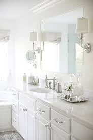 Freshen up in a flash with our top vanity and mirror picks for your bathroom remodel. A White Framed Vanity Mirror Is Lit By Two Polished Nickel Sconces Mounted To The Mirror S Fram Custom Bathroom Vanity Bathroom Countertops Bathroom Sink Decor