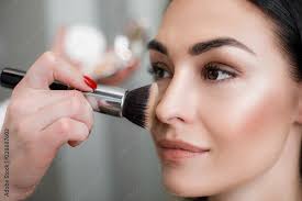 makeup artist applying light layer