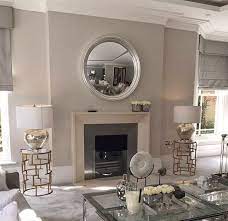 Round Mirrors Over A Fireplace