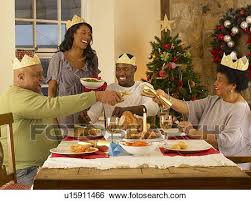 The basic american christmas dinner is british in origin: Adult African American Family Having Christmas Dinner Stock Photograph U15911466 Fotosearch