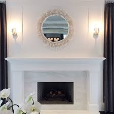 white marble fireplace surround with a