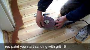 sanding floorboards with the edge
