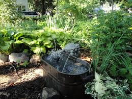 Miniature fountain made from used tin cans, popsicle sticks and straw. How To Add Scent And Sound To Your Garden My Northern Garden