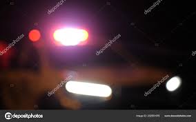 Blurred Police Car Emergency Vehicle Lights In Night Street