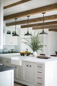 Rustic Beams And Pendant Lights Over A Large Kitchen Island