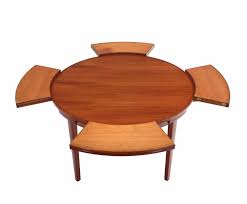 This reclaimed pine wood tabletop is about 2 1/2 inches thick, ensuring it will last for many years. Rare Danish Modern Teak Round Expandable Top Dining Table At 1stdibs
