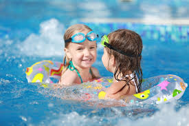 Premium Photo | Children playing in pool. two little girls having fun in the pool.