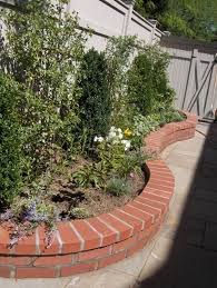 A Curved Red Brick Bed Edging Gives