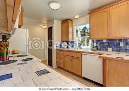 Coastal living natural maple kitchen modern island style white kitchen, maple/beach cabinets,: Kitchen Interior Maple Cabinets And Back Splash Trim Kitchen Interior Maple Cabinets With White And Blue Tile Counter Top Canstock