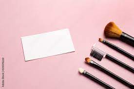 makeup brush and white business card on