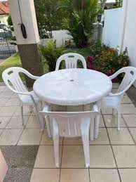 white plastic patio poolside table with