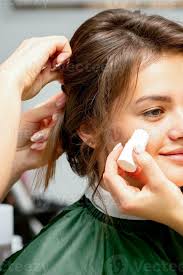 makeup artist applying cream blush
