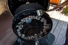 Do you close a charcoal grill after lighting?