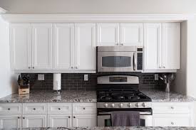Either cabinet refacing or refinishing can save you thousands of dollars on new cabinets! White Kitchen Cabinets After Being Refinished Wide Shot Allen Brothers Cabinet Painting