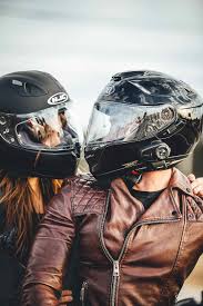 man and woman riding motorcycle helmet