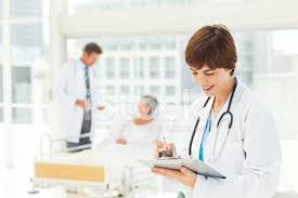 Young Doctor Reading A Medical Chart Stock Photos