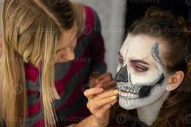 makeup artist puts face painting of a