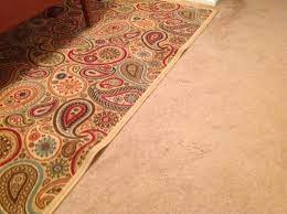 how to keep area rug on carpet flat