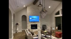q7f 4k tv over stone fireplace