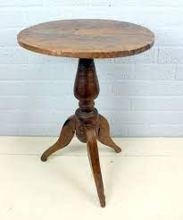 An Antique Round Side Table On Three