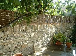 Woven Willow Panels On Drystone Wall