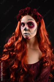 woman with sugar skull makeup and red