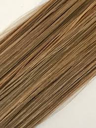 Blonde hair extensions in female hand isolated on white. Hair Extensions 18 Micro Loop Natural Straight 8 Dark Ash Blonde Labella Hair Extensions
