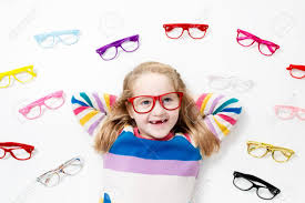 Child At Eye Sight Test Little Kid Selecting Glasses At Optician