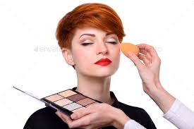makeup artist applying foundation on