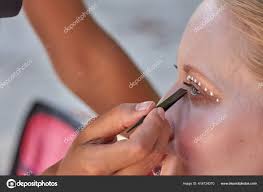 makeup artist working applying pearl